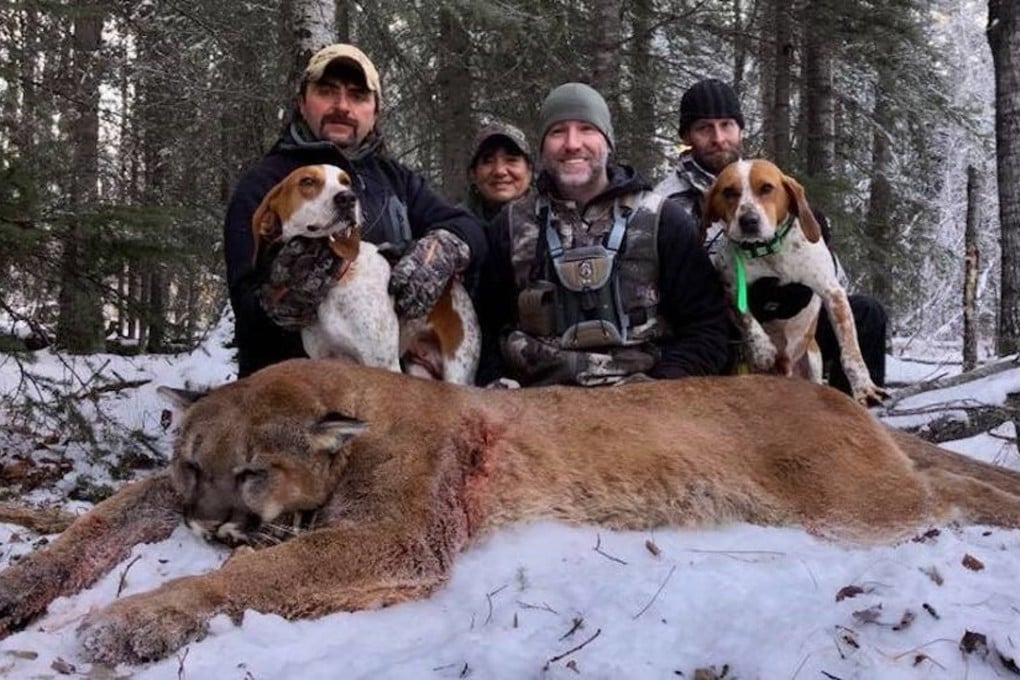 Steve Ecklund (centre), host of The Edge outdoor show, poses with a cougar he hunted and killed in Alberta. When he posted photos of the kill on his Facebook page, he drew a fierce backlash. Photo: Steve Ecklund / Facebook