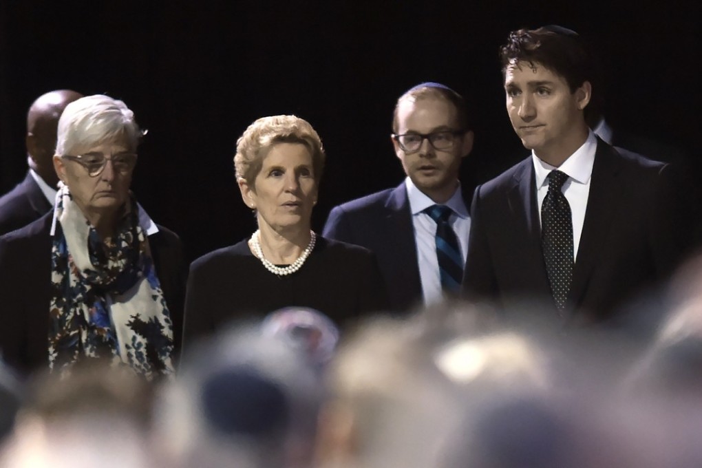 Canadian Prime Minister Justin Trudeau, right, and Ontario Premier Kathleen Wynne, centre, arrive at the memorial service for Apotex founder Barry Sherman and his wife Honey in Mississauga, Ontario on Thursday. Photo: AP
