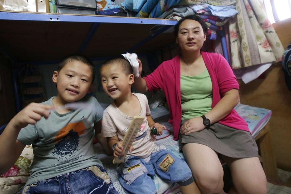 A mother and her two children living in a rooftop shack in Hoi Tan Street in Hong Kong pose for a photo in an interview. Existing levels of child poverty are intolerable, not least because the government has ample means to tackle the problem. Photo: David Wong