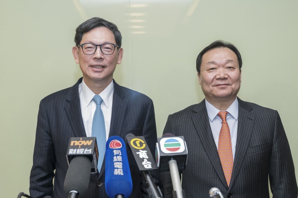Norman Chan, chief executive of the Hong Kong Monetary Authority (left), and Yue Yi, chairman of the Hong Kong Association of Banks (HKAB) (right) speaking to reporters as they concluded the annual HKAB Beijing trip. Photo: SCMP Handout
