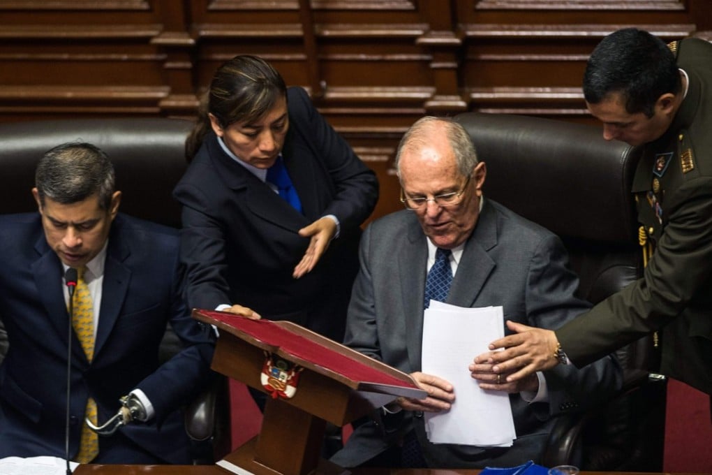 Peruvian President Pedro Pablo Kuczynski (second right) is pictured next to the President of the Congress Luis Galarreta (left) after delivering a speech before the Peruvian National Congress in Lima in defence against a motion of impeachment. Photo: Agence France-Presse