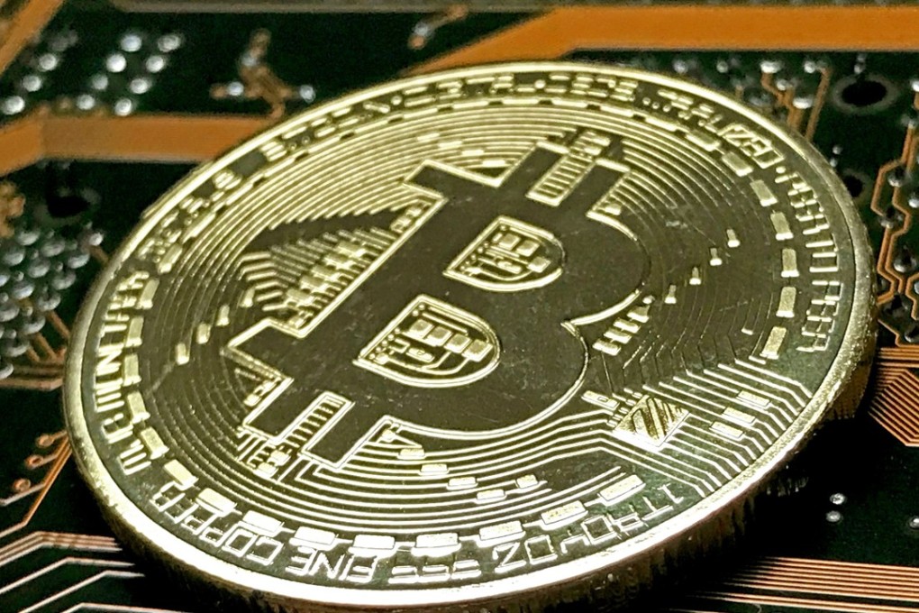 A golden symbolic bitcoin is pictured in Düsseldorf, Germany. The virtual currency has dropped from a record high it hit less than a week ago. The cryptocurrency, which allows anonymous transactions unrestricted by global borders, is popular with tech heads, people suspicious of government and those seeking to launder money. Photo: EPA-EFE