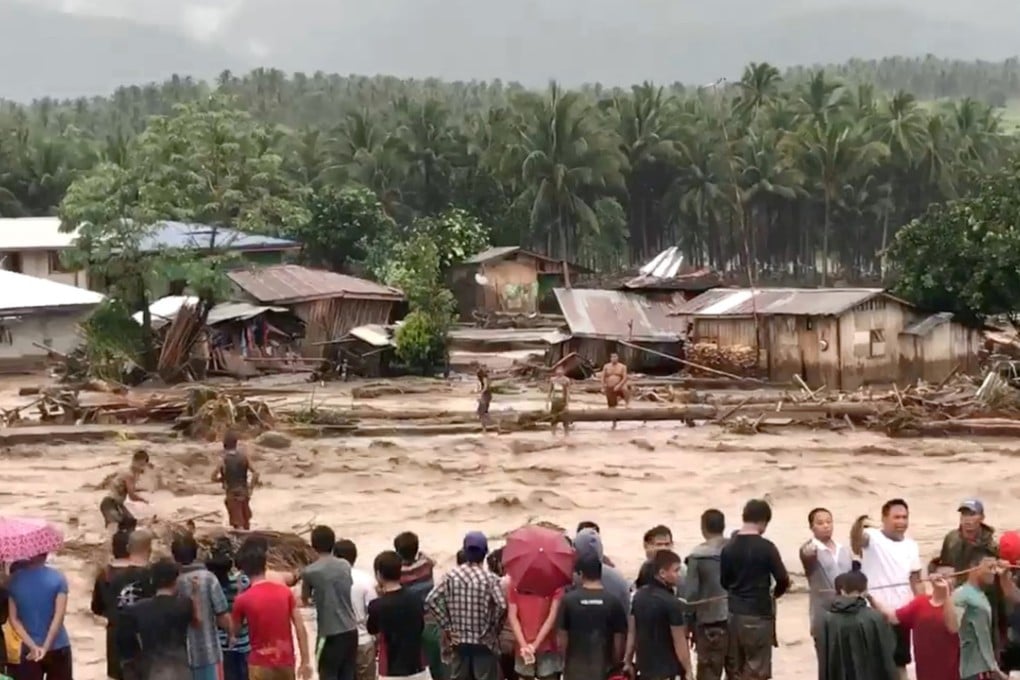 People try to rescue flood victims in Lanao Del Norte, Philippines. Photo: Reuters