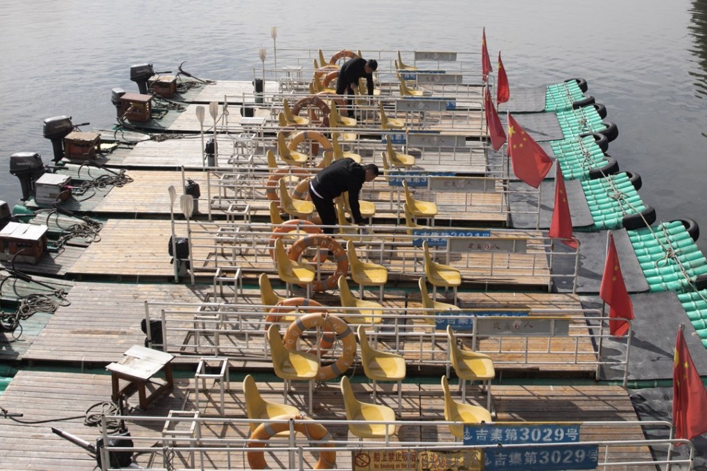 Boatmen prepare rafts for tourists who want to get a closer look at the neighbouring country along the Yalu river between North Korea on the left and China on the right. Photo: AP