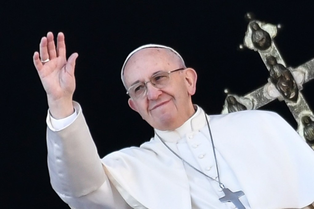 Pope Francis waves from the balcony of St Peter's Basilica. Photo: AFP