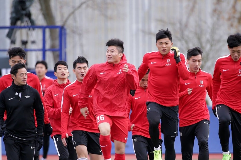 China's Under-20 players warm up before their match against TSV Schott Mainz. Photo: AFP