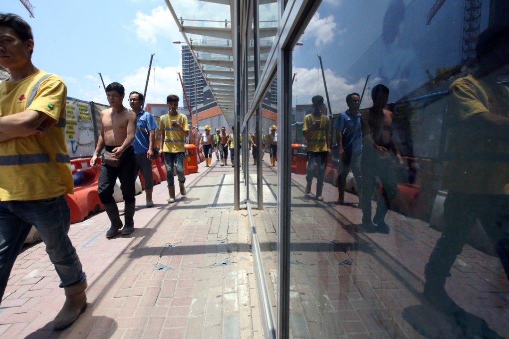 Construction workers at the West Kowloon Cultural District in July last year. The Hong Kong education system tends to undersupply blue-collar workers. Photo: Felix Wong
