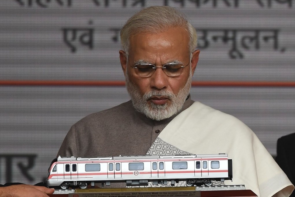 India Prime Minister Narendra Modi looks at a model of New Delhi’s metro train. Photo: AFP