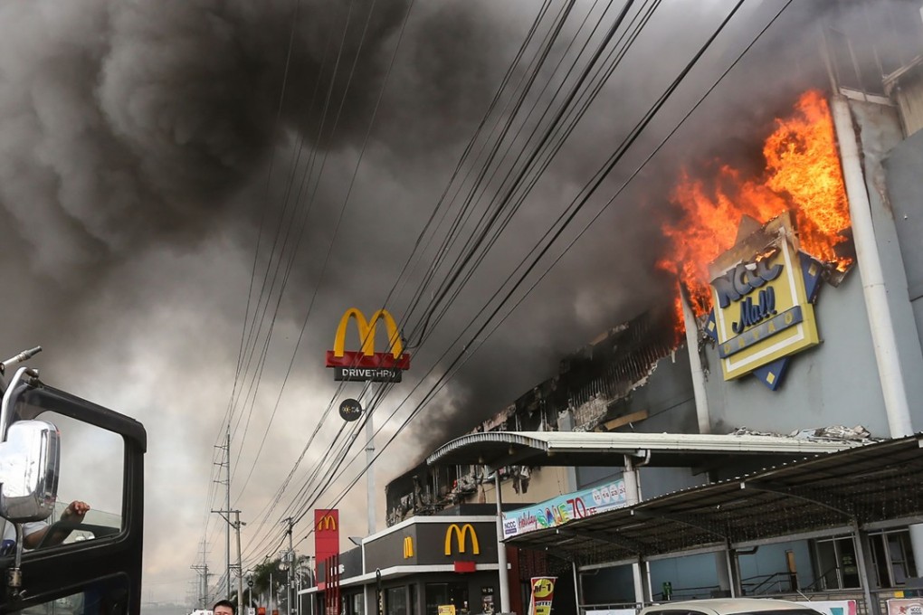 Firefighters recovered the bodies of 37 people from this blaze at a shopping centre in the Philippines city of Davao. Photo: AFP