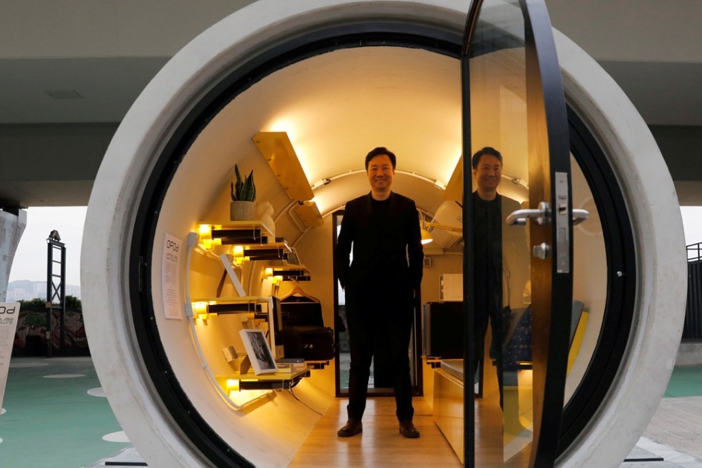 Architect James Law poses earlier this month inside his work, the "Opod" – a 120-square foot giant water pipe, designed as micro-housing in Hong Kong. Photo: Reuters