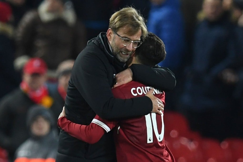 Jurgen Klopp hugs Liverpool midfielder Philippe Coutinho after the final whistle. Photo: AFP