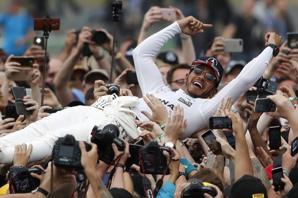 Mercedes driver Lewis Hamilton celebrates after winning the British Grand Prix at Silverstone. Photo: AP