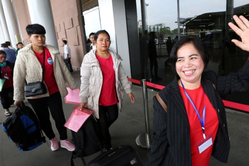 A Cambodian maid waves as she leaves with others for Hong Kong from Phnom Penh. Photo: AFP