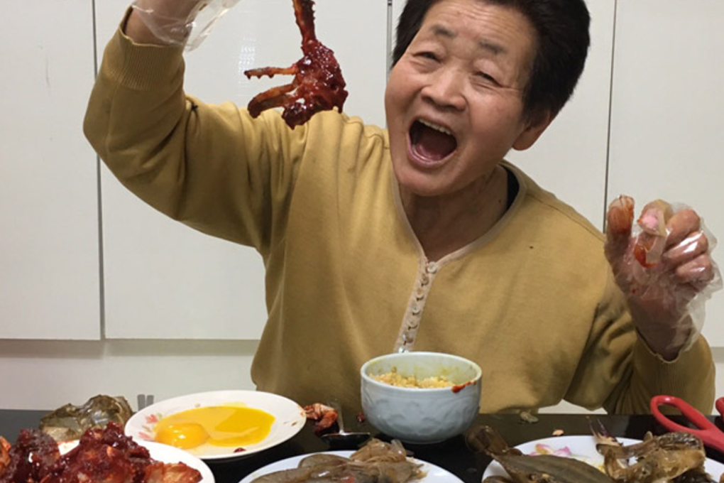 Kim Young-won, a 77-year-old host of YouTube channel "Youngwonssi TV _ Funny Grandmother," tries new foods during the mukbang (eating show) broadcasting, at her home in Yongin, Gyeonggi Province. Photo: Youngwonssi TV