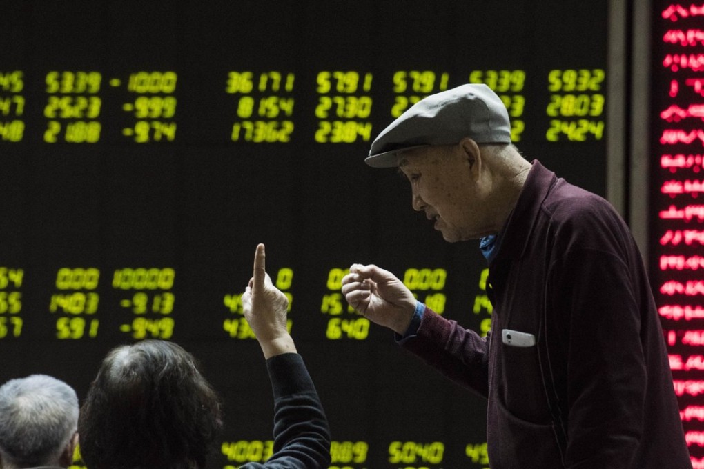 Investors look at screens showing stock market movements at a securities company in Beijing. Experts say China’s elderly can be particularly vulnerable to risky or even fraudulent investments, such as P2P online lending. Photo: AFP