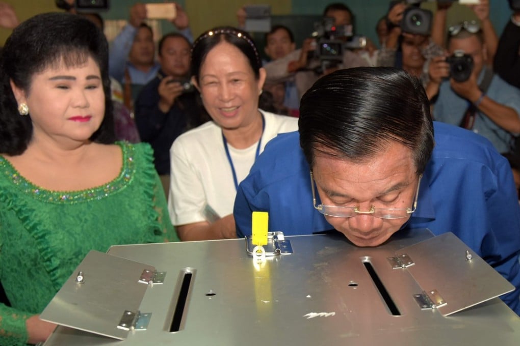 Cambodian Prime Minister Hun Sen looks at a ballot box after he cast his vote a polling station for local polls in June. File photo: AFP