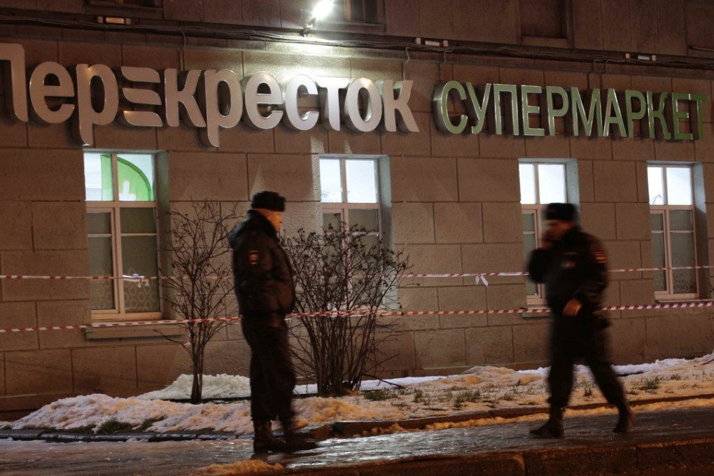 Policemen are seen outside a St Petersburg supermarket after an explosion there injured 10 people on Wednesday. Authorities have declined to refer to the act as terrorism, instead classifying it as “attempted murder of two or more people”. Photo: Reuters