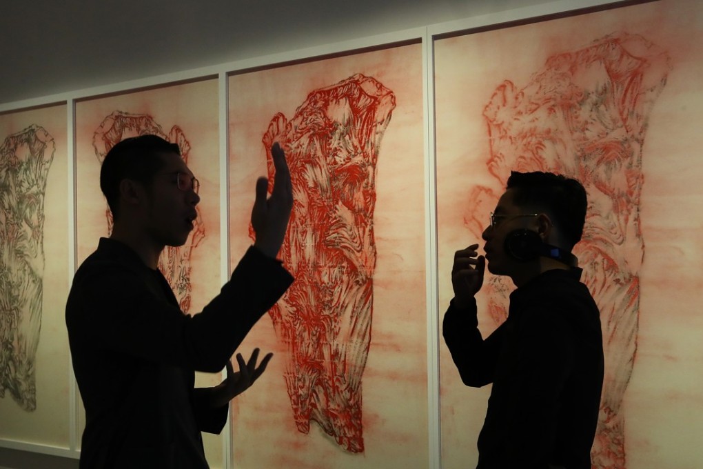 Artist Ni Youyu talks to Hung Fai, whose work The Six Principles of Chinese Painting – Transmission IV hangs behind them, at the M+ Pavilion of the West Kowloon Cultural District. Photo: Nora Tam