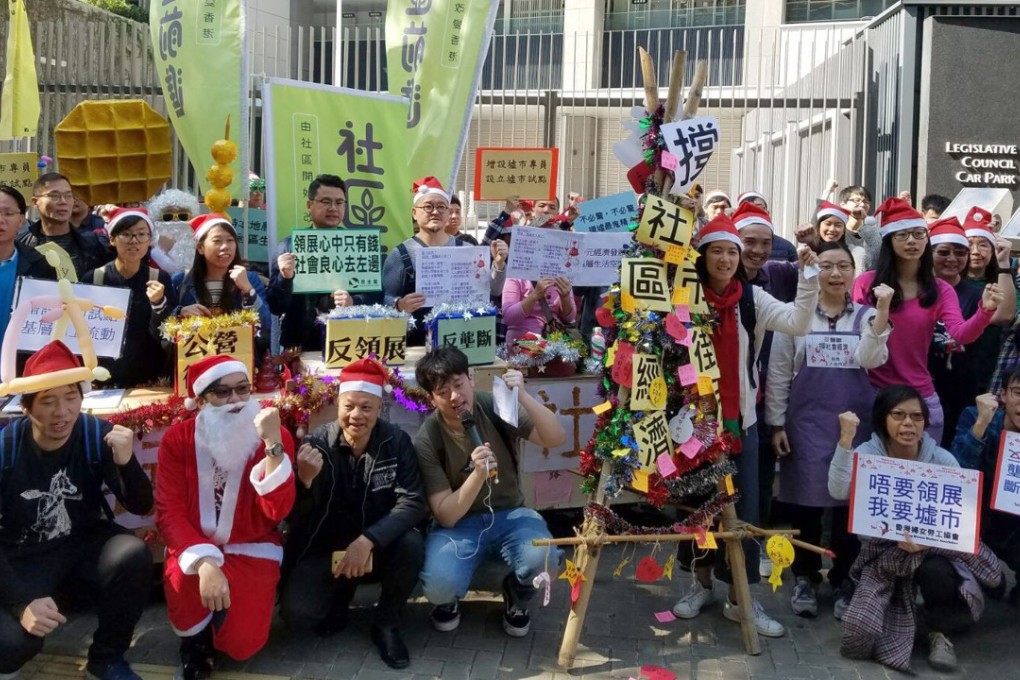 More than 20 concern groups call for markets catering to grass-roots households, as they march from Wan Chai to the government headquarters in Tamar on Christmas Eve. Photo: Handout