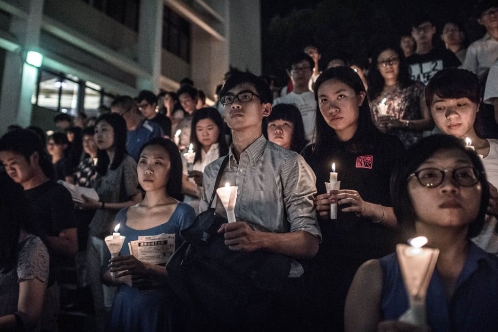 Participants hold candles during a vigil organised by students to commemorate the 1989 Tiananmen Square crackdown at the University of Hong Kong, in June 2015. Photo: AFP