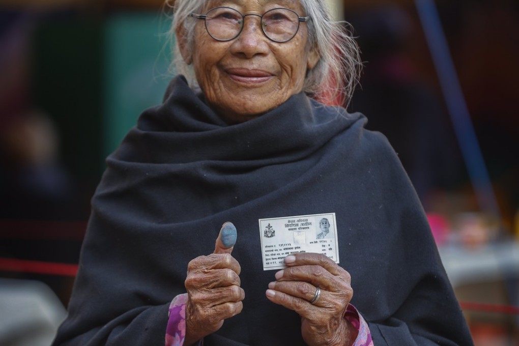 Asha Maya Dangol, 80, shows her thumb print after casting her vote in Kathmandu, in the elections on December 7. Nepal's leftist alliance prevailed in the elections. After two decades of conflict and political stability, Nepalis hope the alliance can deliver stable governance and economic development. Photo: EPA-EFE