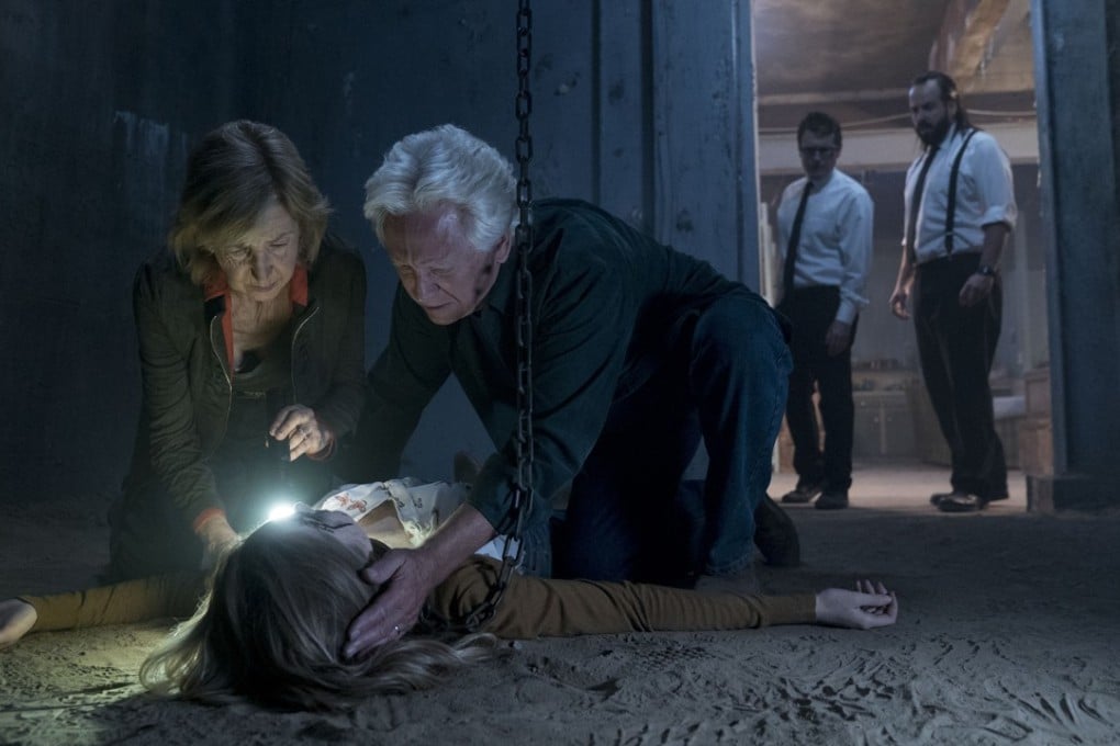 Lin Shaye (left) and Leigh Whannell (second from right) in Insidious: The Last Key.