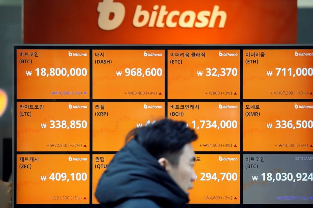 A man walks past an electric board showing exchange rates of various cryptocurrencies including bitcoin at a cryptocurrencies exchange in Seoul. Photo: Reuters