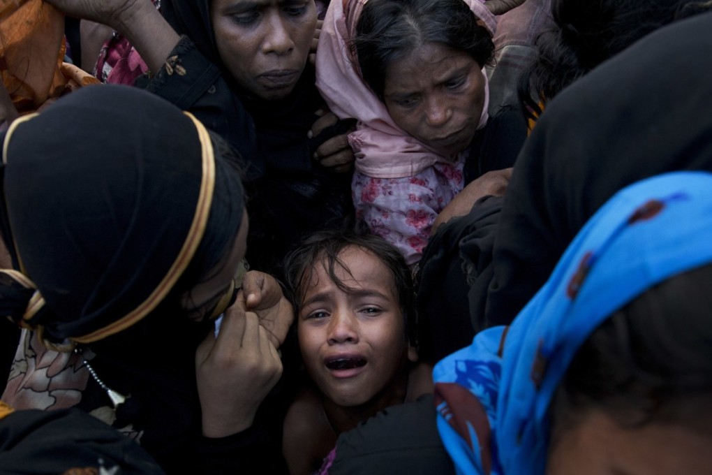 A Rohingya Muslim child cries as she stands amid a crowd receiving food rations near a refugee camp in Cox's Bazar, Bangladesh in September. Photo: AP