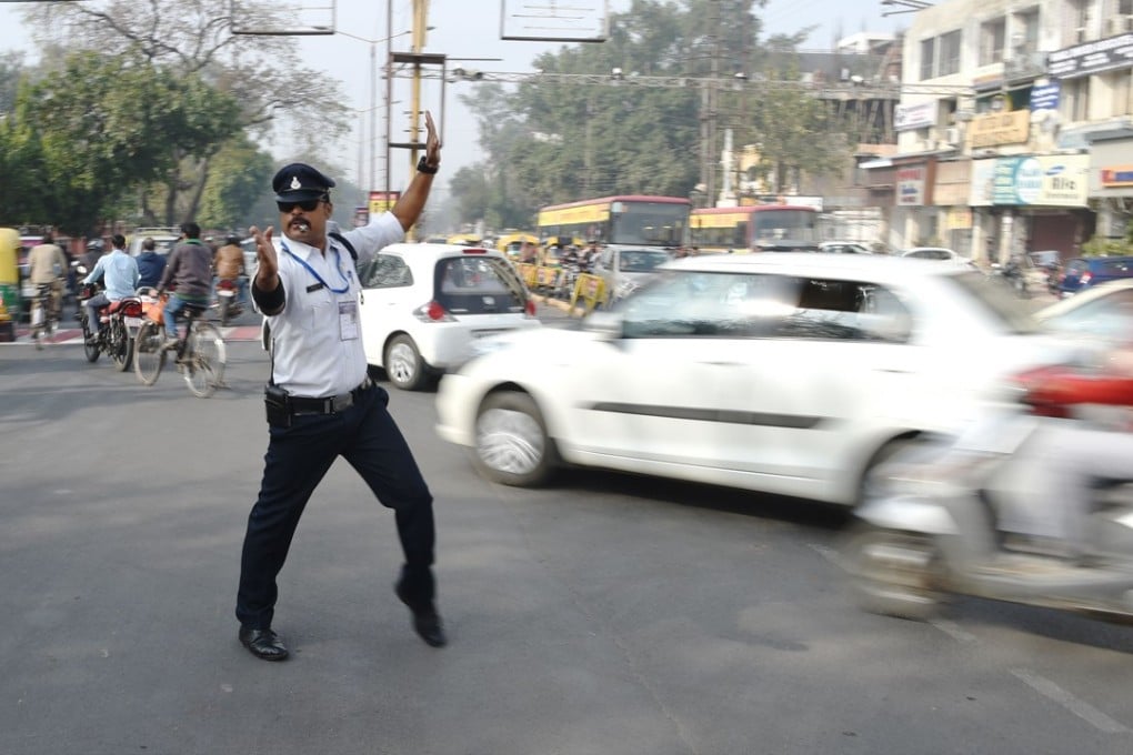 Indian traffic policeman Ranjeet Singh directs traffic while ‘moonwalking’ at an intersection in Indore. Photo: AFP