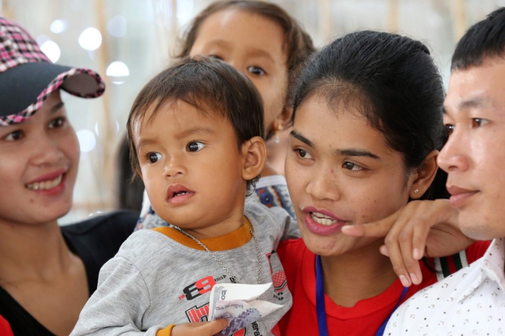 Kon Sokea (second right), says goodbye to her son in Cambodia before travelling to work as a domestic helper in Hong Kong. Photo: AFP
