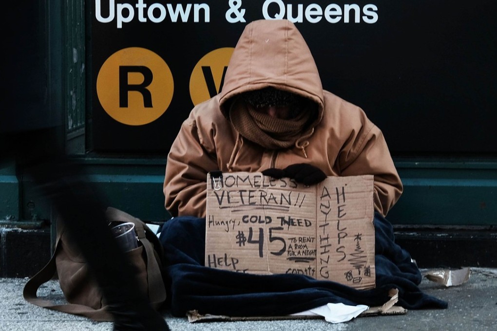 US authorities are asking people to extend help to homeless and elderly people as arctic winds freeze half the country. Pictured: a homeless man in New York on Wednesday. Temperatures will be well into the minus figures when the New Year’s Eve celebrations take place in the city this weekend. Photo: Getty Images/AFP