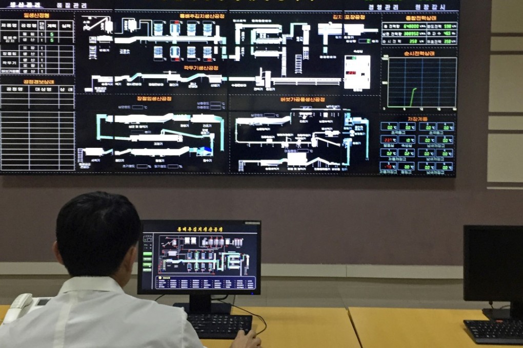 An employee monitors production from the control room of the Ryugyong kimchi factory in Pyongyang. Photo: AP