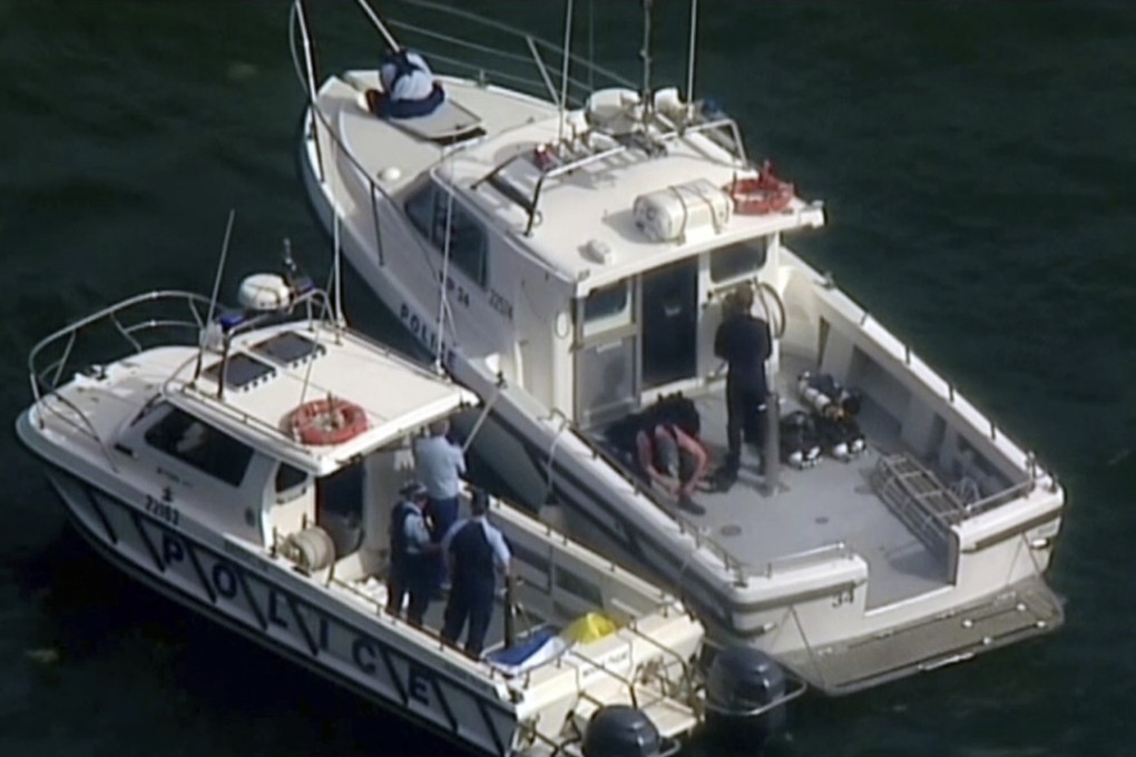 Police search and rescue teams on back of boats in the Hawkesbury River. Photo: AP