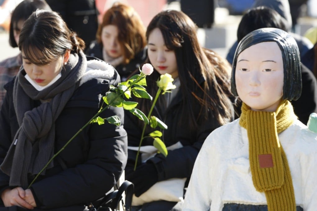 Participants sit on 300 chairs placed at Gwanghwamun Square in a performance themed 'A Promise Inscribed on an Empty Chair' after finishing this year's final weekly rally in front of the Japanese Embassy in Seoul, South Korea, calling for Japan's apology for its army's sexual enslavement of hundreds of thousands of Korean women during World War II. Such victims are euphemistically called 'comfort women.' Photo: EPA
