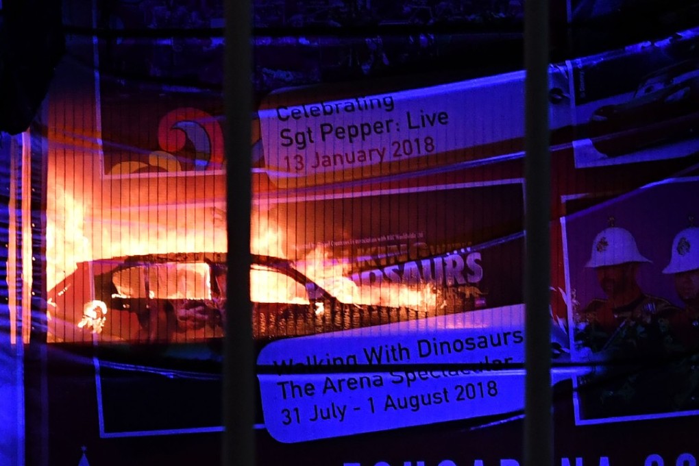 Cars burn during a blaze engulfing vehicles parked at a multi-storey car park near the Echo Arena, at the waterfront in Liverpool. Photo: AFP