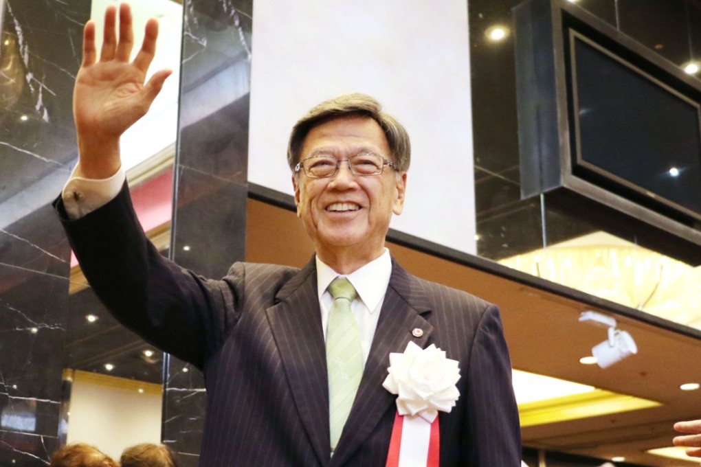Okinawa Governor Takeshi Onaga waves to his supporters at a fundraising party in Naha. Photo: Kyodo