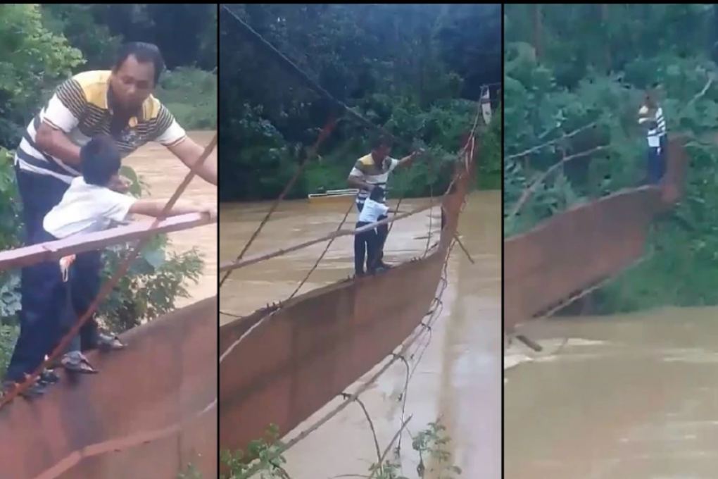 A videograb showing the father guiding his child across the broken bridge as they make thier journey to Sekolah Batu Yon, Bukit Betong. Photo: New Straits times