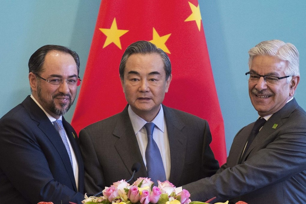 China's Foreign Minister Wang Yi (centre), Afghanistan's Foreign Minister Salahuddin Rabbani (left) and Pakistan's Foreign Minister Khawaja Muhammad Asif shake hands at the end of a joint press conference and after the first China-Afghanistan-Pakistan Foreign Ministers' Dialogue in Beijing. Photo: AFP