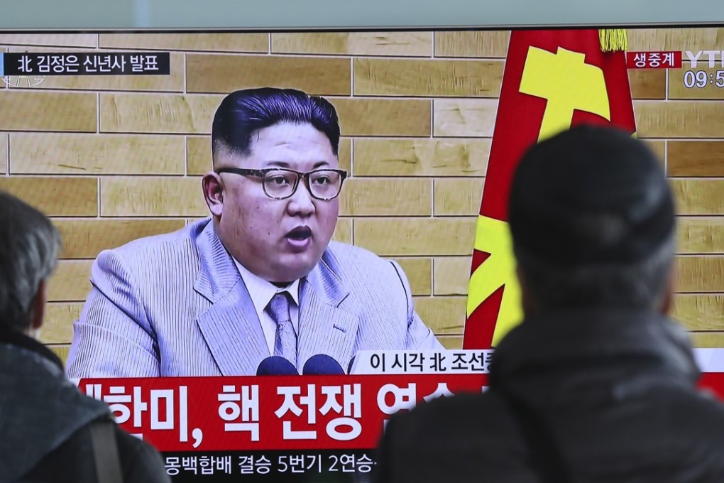 Commuters stop to watch a TV news programme showing North Korean leader Kim Jong-un’s New Year address, at the Seoul Railway Station on January 1. Photo: AP