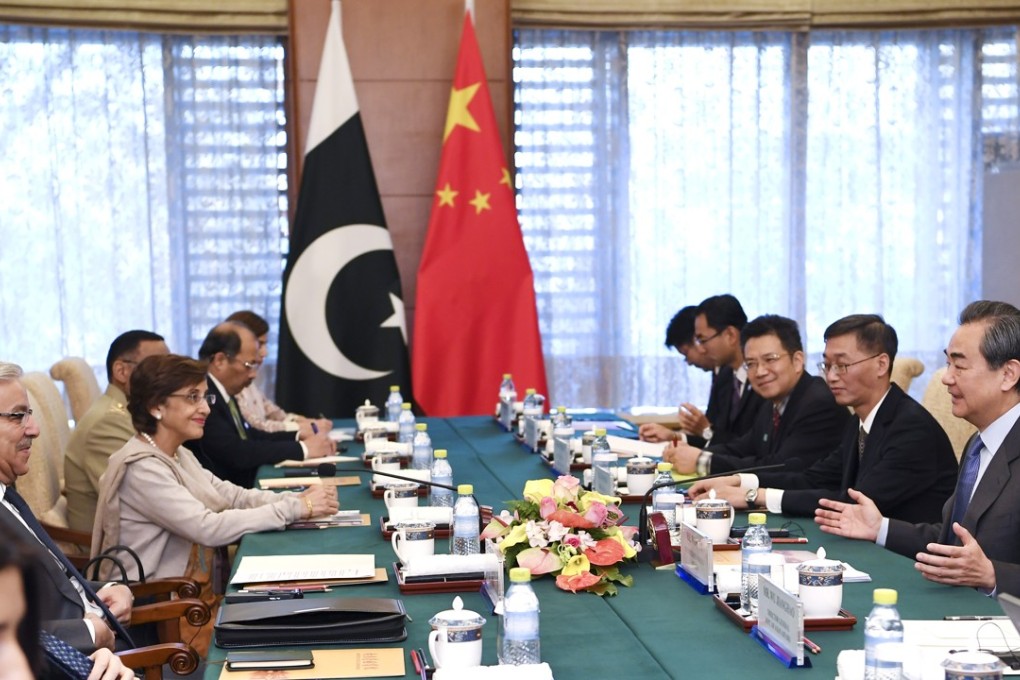 Chinese Foreign Minister Wang Yi (far right) meets with Pakistani Foreign Minister Khawaja Muhammad Asif (far left, in glasses). Bilateral trade can now use the yuan, boosting economic ties between the countries. Photo: Xinhua
