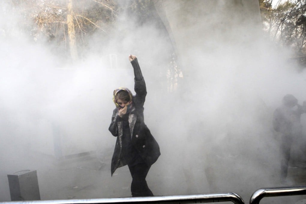 A university student attends a protest inside Tehran University, Iran, while swathed in smoke from riot police. Iran’s population could lead to it developing a democracy, a US-based forecaster predicts, because its population is of a perfect age to both protest and develop democracy. Photo: AP