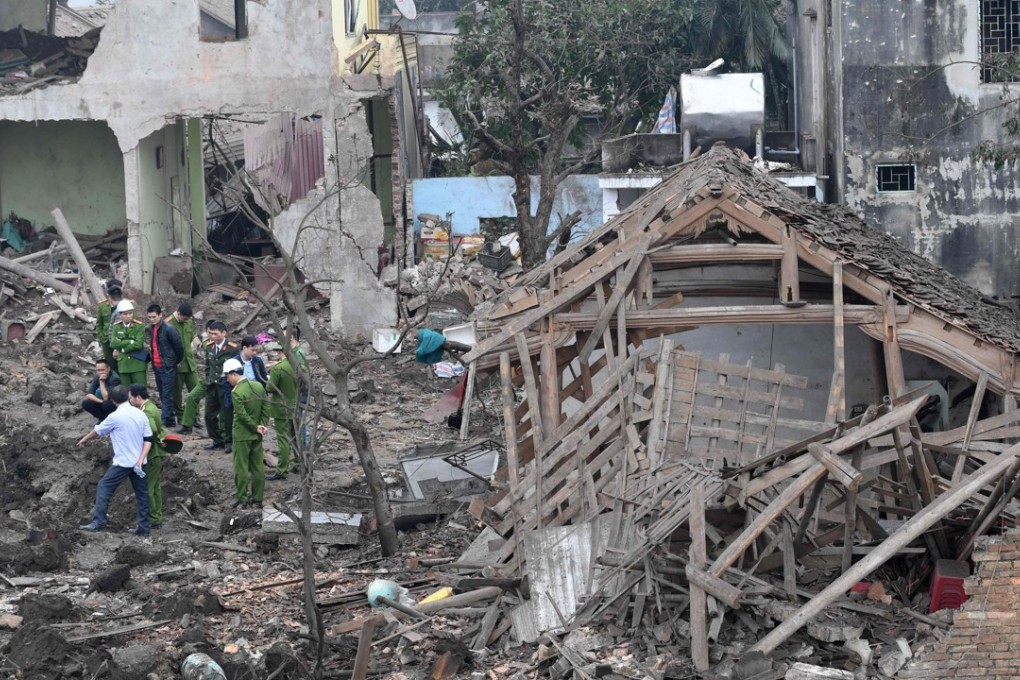 Soldiers and rescuers stand at the site after an explosion razed five homes and shattered windows of surrounding buildings. Photo: AFP