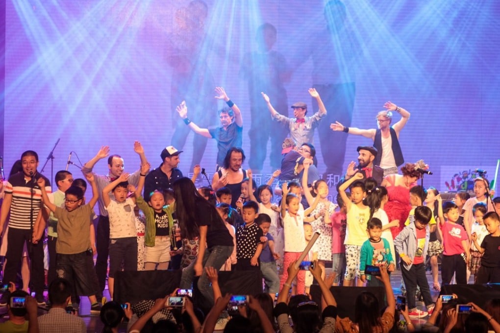 Children and parents taking the stage during a performance by Lucky Diaz and the Family Jam Band at the Hand in Hand Music Festival.