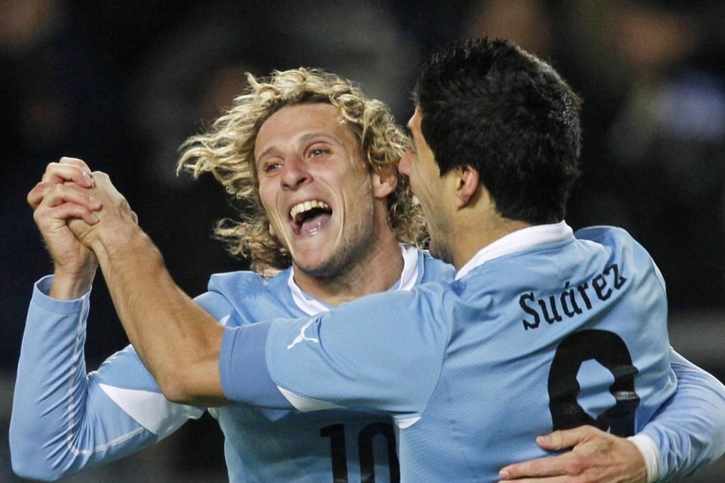 Uruguay's Diego Forlan celebrates with Luis Suarez during their Copa America semi-final win in 2011. Photo: Reuters