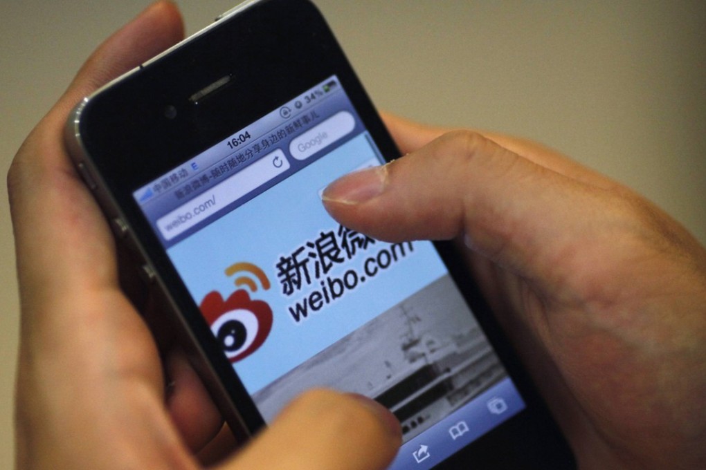 A man uses his smartphone to access the Sina Weibo microblogging site in Shanghai. China’s Cybersecurity Law, introduced in June last year, requires network operators to store select data on servers within the country, monitor and record network operations, and maintain related logs for not fewer than six months. Photo: Reuters