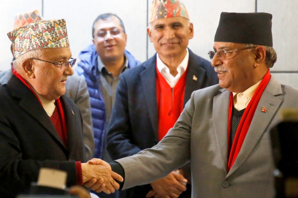 Khadga Prasad (K.P.) Sharma Oli (left), chairman of the Communist Party of Nepal (Unified Marxist-Leninist), greets Pushpa Kumar Dahal “Prachanda”, chairman of the Communist Party of Nepal (Maoist Centre), during a news conference in Kathmandu on December 17. Photo: Reuters