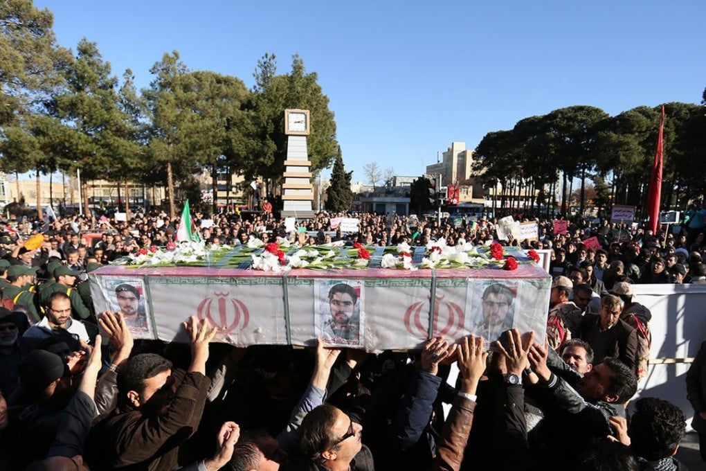 Iranian pro-government supporters march during the funeral of a young member of the Revolutionary Guards, Sajjad Shahsanai, in the city of Najafabad, west of Isfahan, on January 3, 2018. The head of the Guards declared an end to the unrest. Photo: AFP