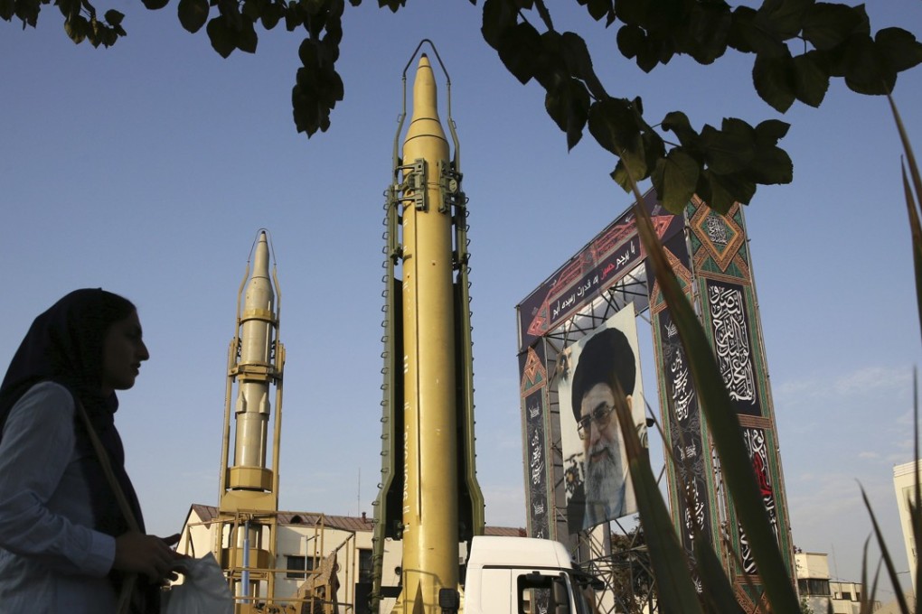 In this September 24, 2017 file photo, a Ghadr-H missile, centre, a solid-fuel surface-to-surface Sejjil missile and a portrait of the Supreme Leader Ayatollah Ali Khamenei are displayed at Baharestan Square in Tehran, Iran. The US imposed sanctions on Iranian companies because of the missile programme. Photo: AP