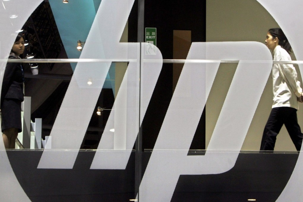 An employee walks past a Hewlett-Packard logo in Hong Kong in this file photo. Photo: Reuters