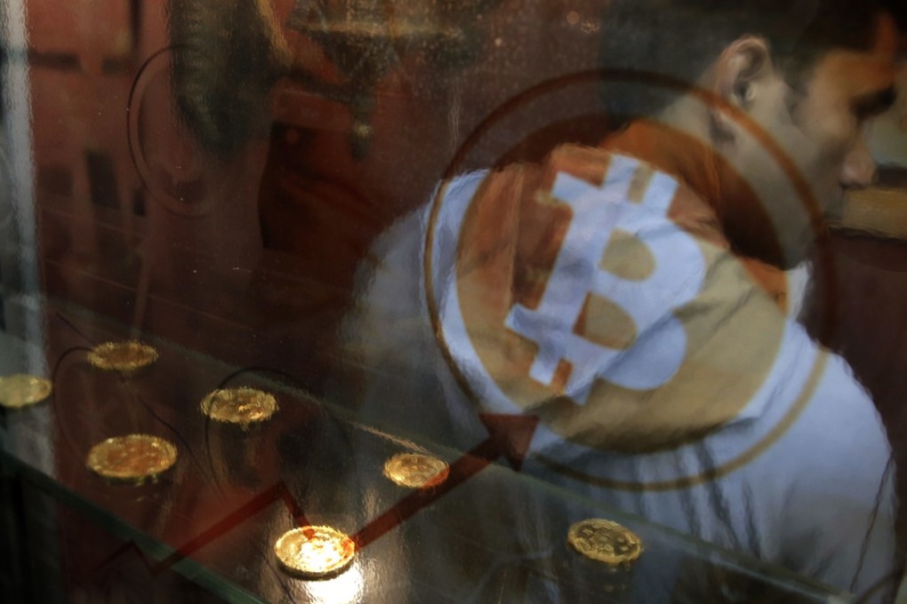A man uses a bitcoin ATM in Hong Kong. A recent YouGov survey in the US said that 62 per cent of respondents either had never heard of bitcoin or believed it was for criminals. Photo: AP
